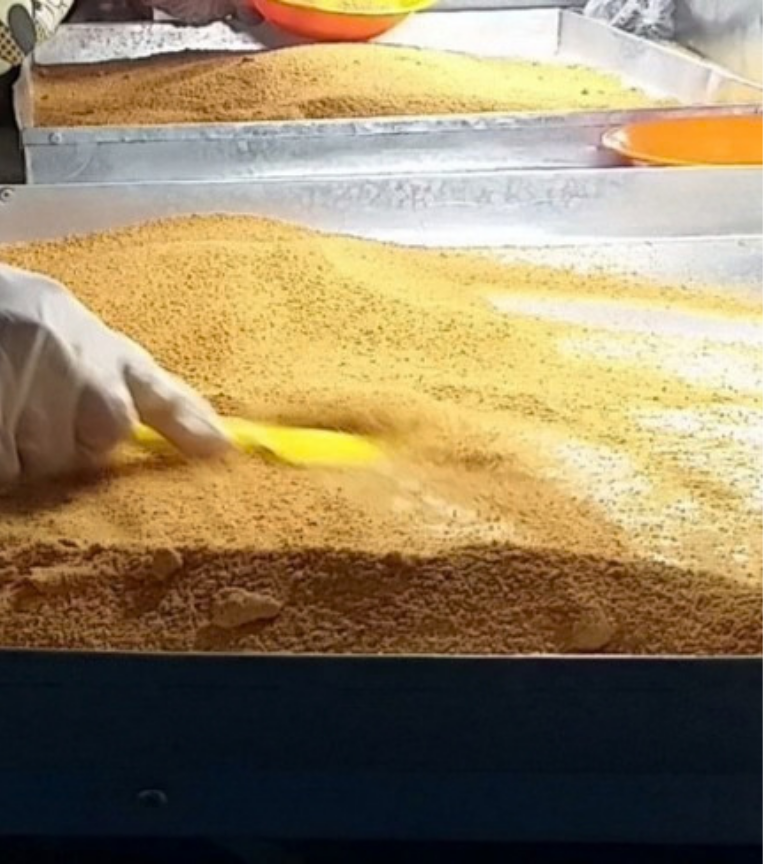 Workers sorting coconut sugar across processing trays